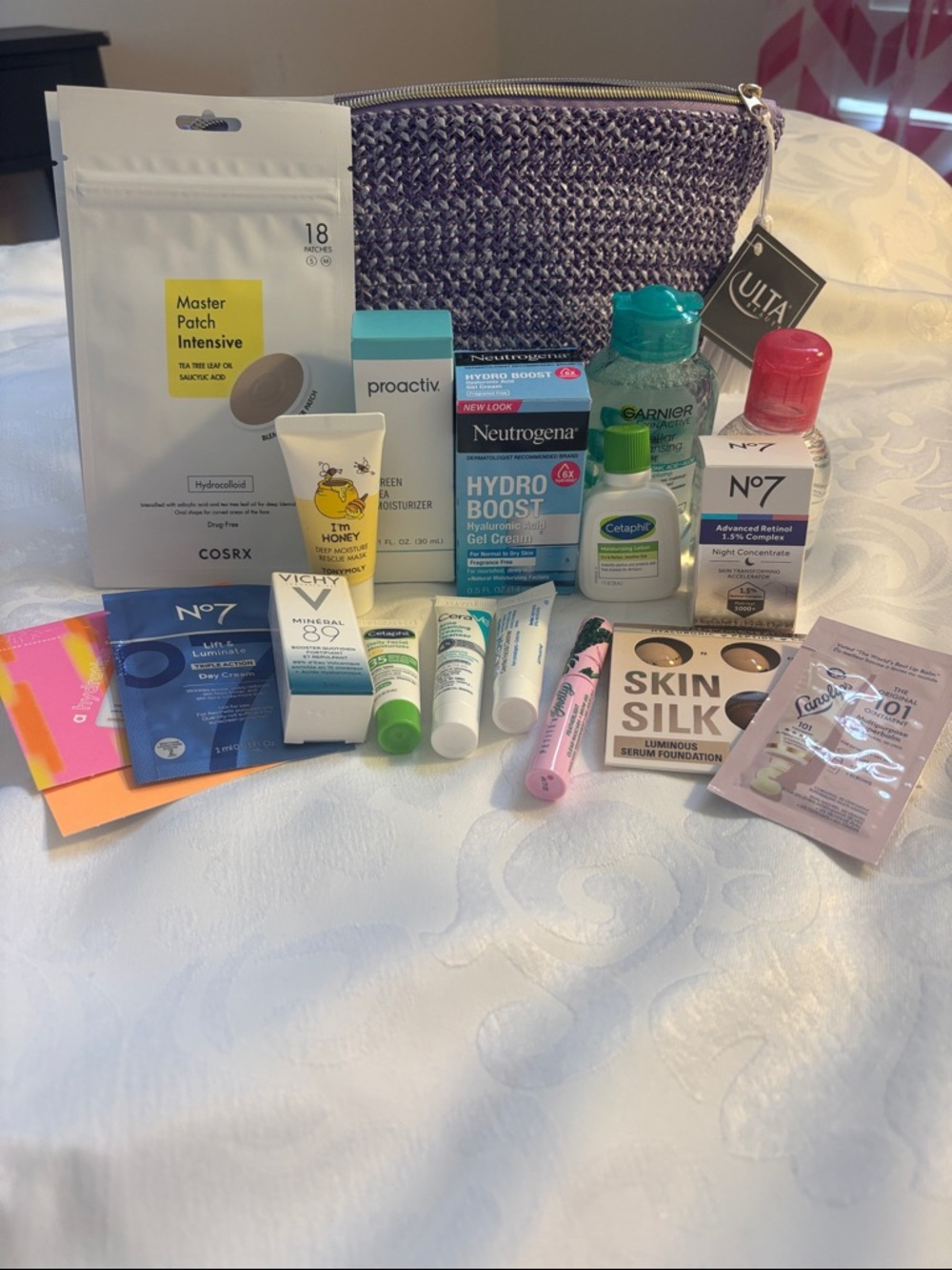 Assorted Skincare & Makeup with Purple Cosmetic Bag
